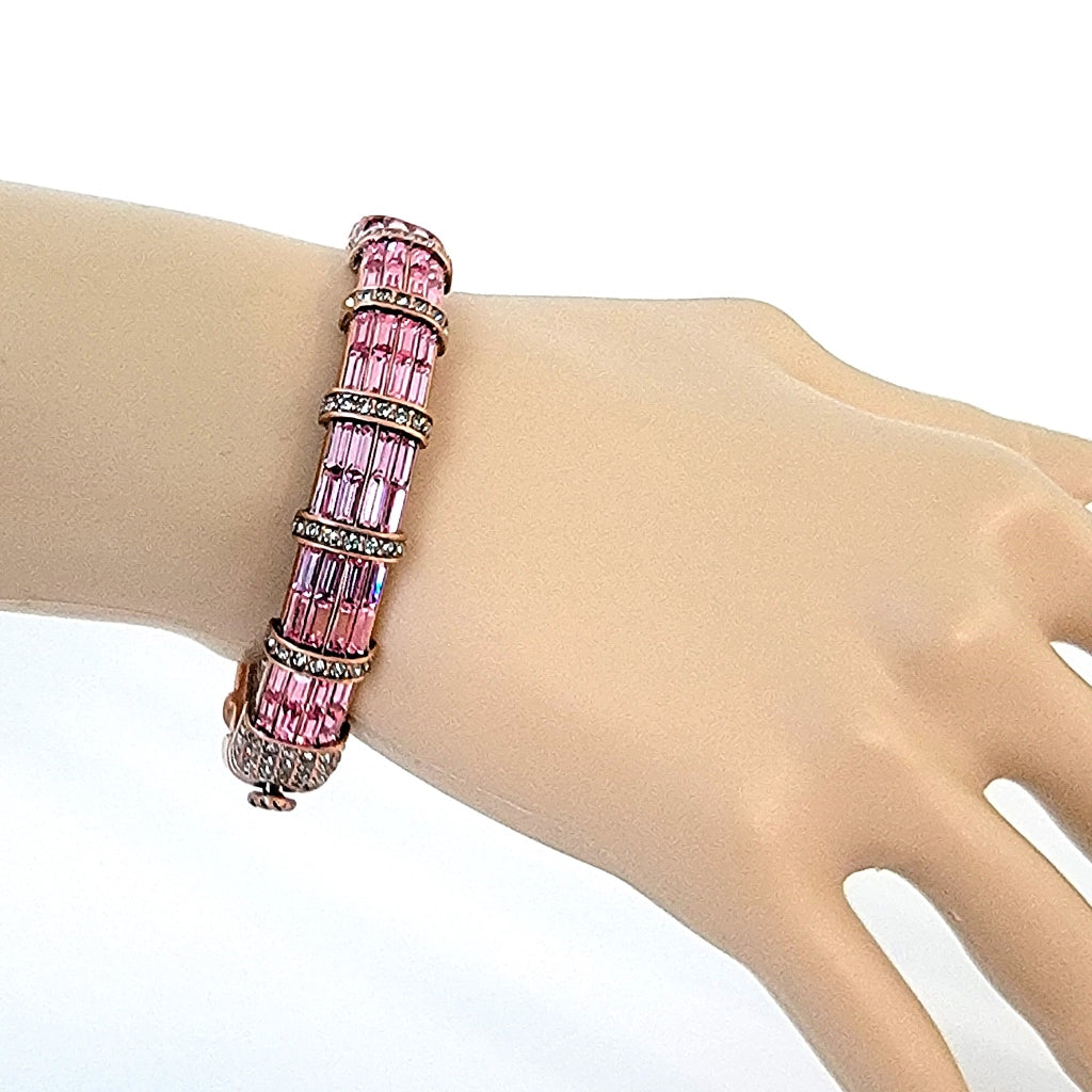 Pink rhinestone bracelet on wrist.