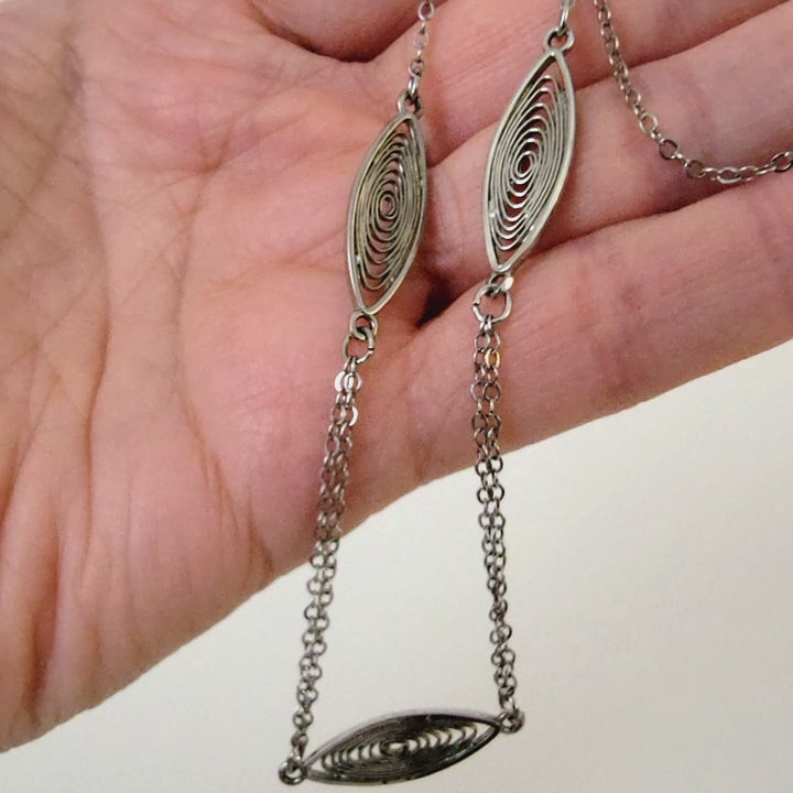 Minimalist choker in hand.