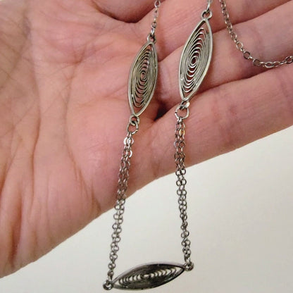 Minimalist choker in hand.