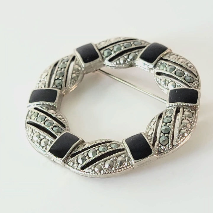 1928 black enamel brooch.
