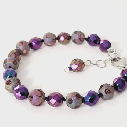 Purple beaded bracelet displayed on a turntable.