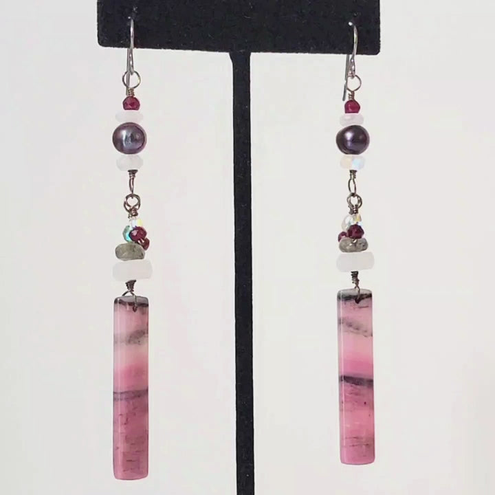 Video of long dangling pink gemstone earrings, with moonstones and pearls.