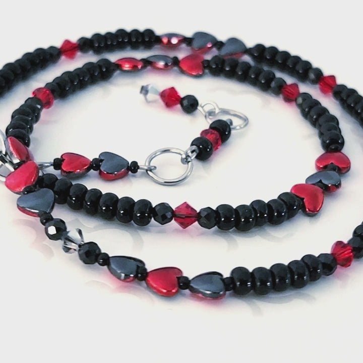 Black and red beaded necklace with hearts.