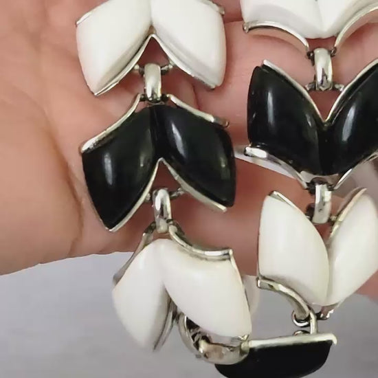 Vintage black and white vintage necklace in hand.
