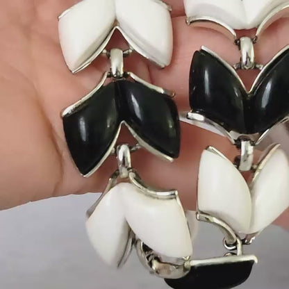 Vintage black and white vintage necklace in hand.