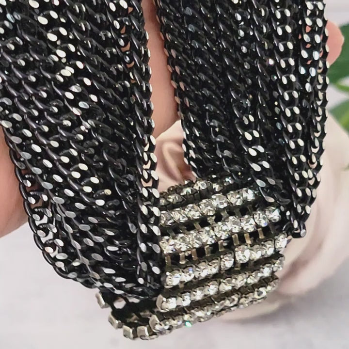Black multistrand chain choker in hand.