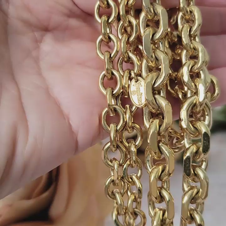 Vintage midcentury style gold chain necklace in hand.