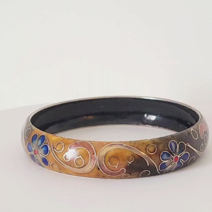 Video of a cloisonne enamel bracelet with blue flowers.