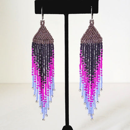 Long purple ombre seed bead fringe earrings, on a display stand.