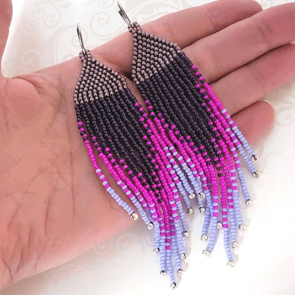 Long purple ombre seed bead fringe earrings, shown in hand, for size comparison.