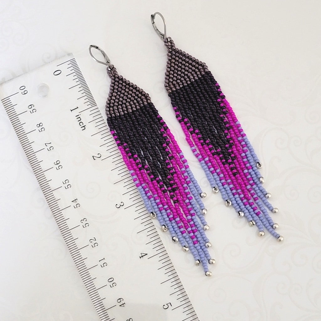 Purple seed bead dangle fringe earrings, next to a ruler.
