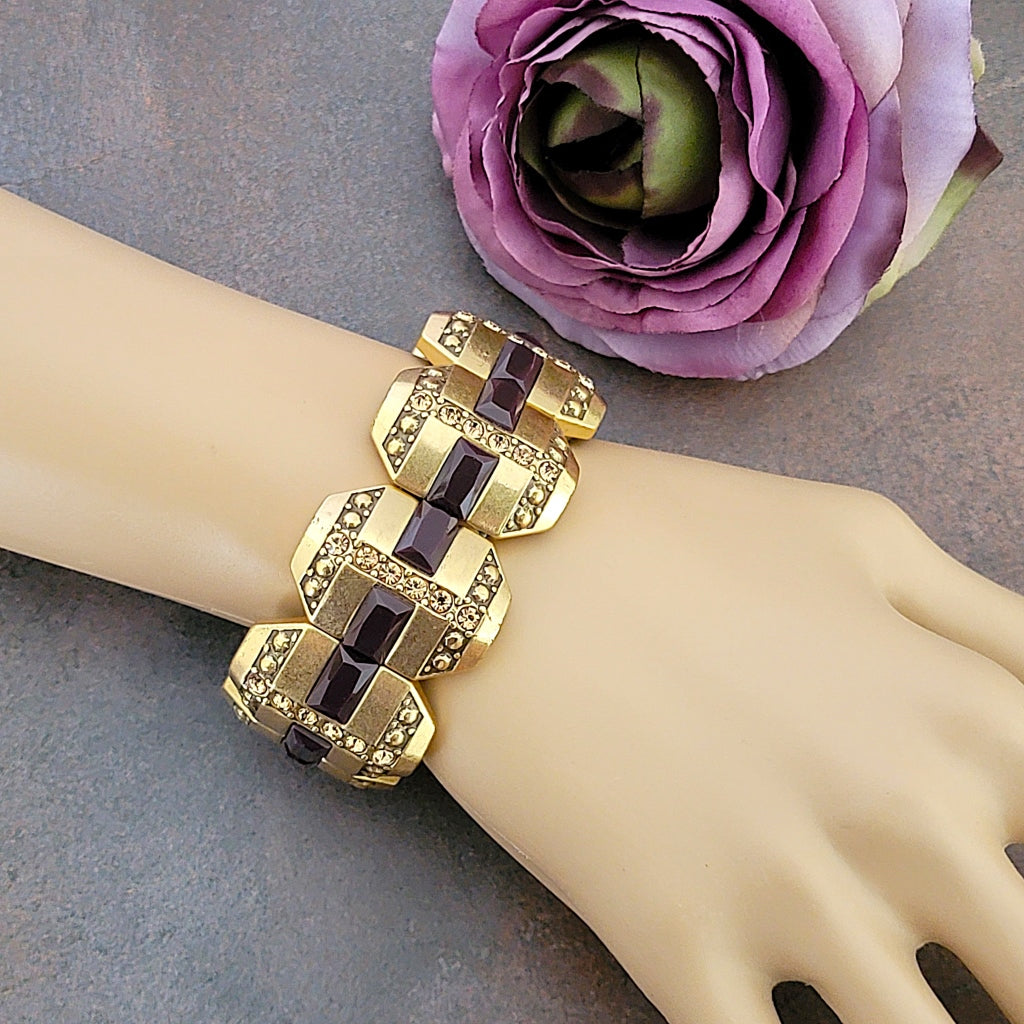 Gold tone rhinestone stretch bracelet on wrist.