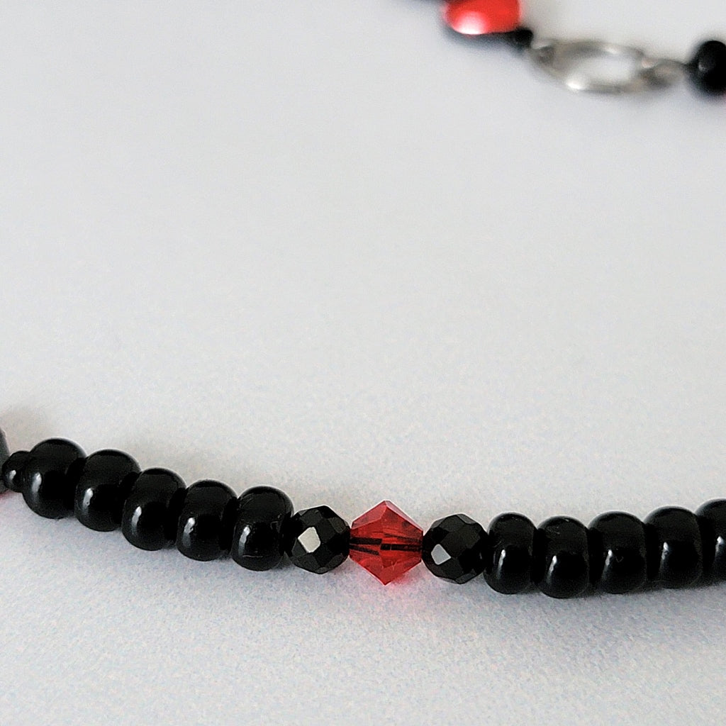 Red crystal and black glass beads.