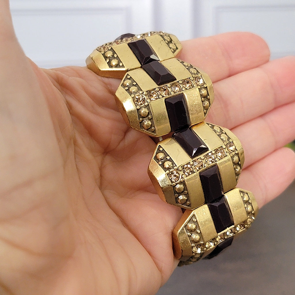 Gold rhinestone bracelet in hand.