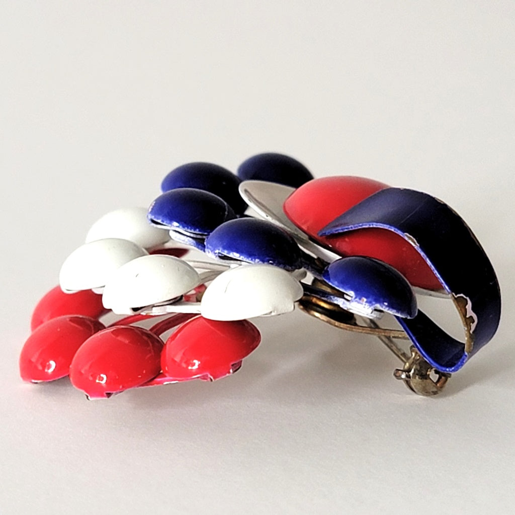 Side view of layered enamel pin.
