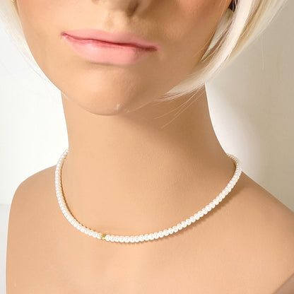 Minimalist pearl and gold crystal choker, shown on a mannequin.