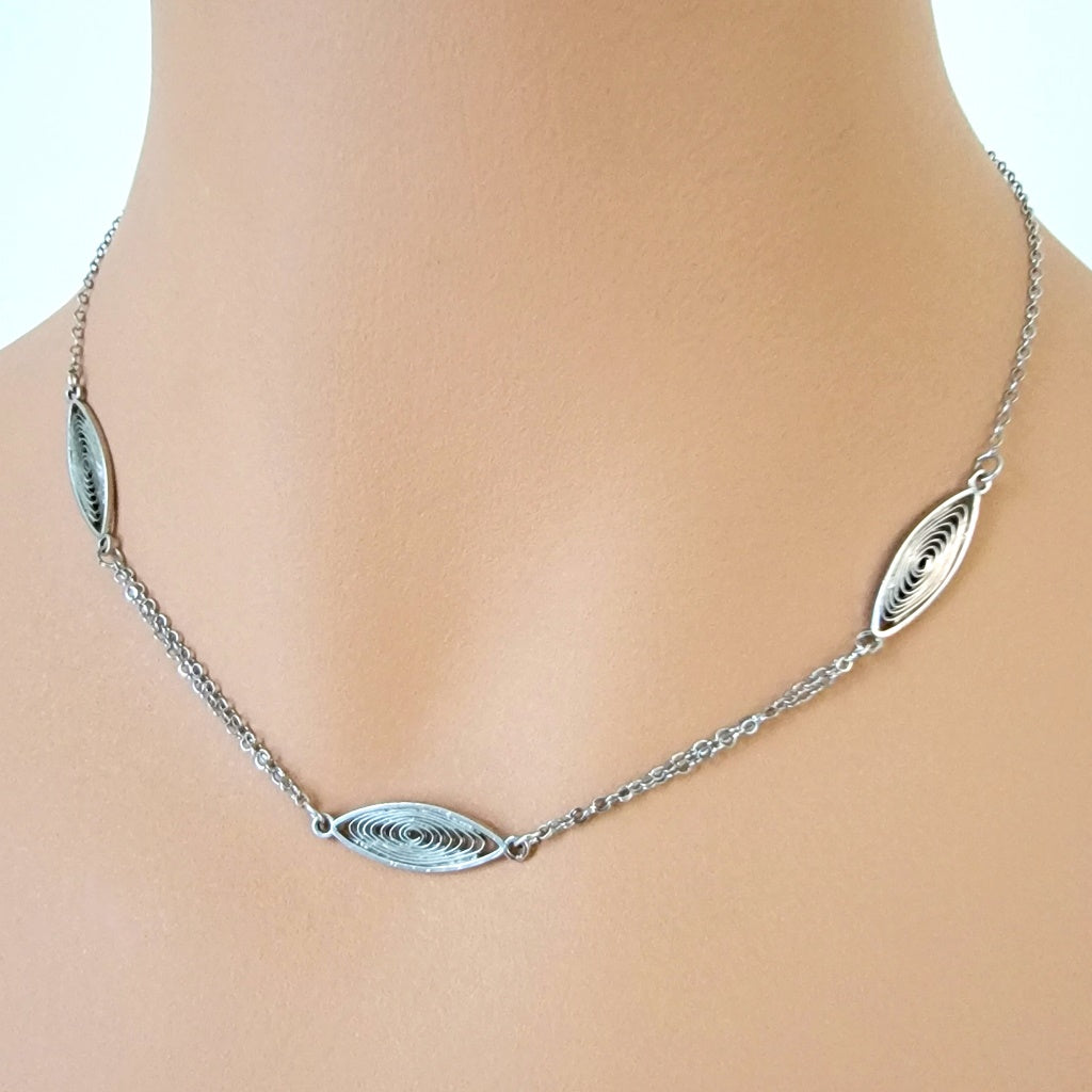 Minimalist silver tone choker on mannequin.