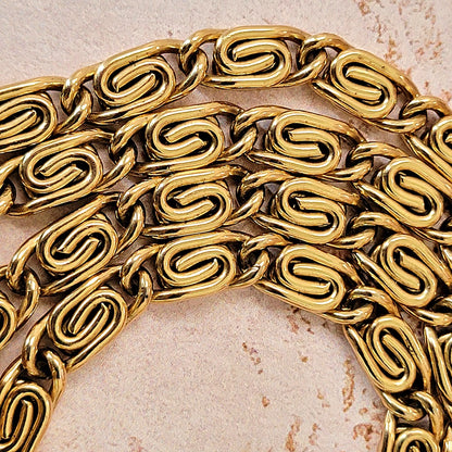 Thick gold tone snail chain links.