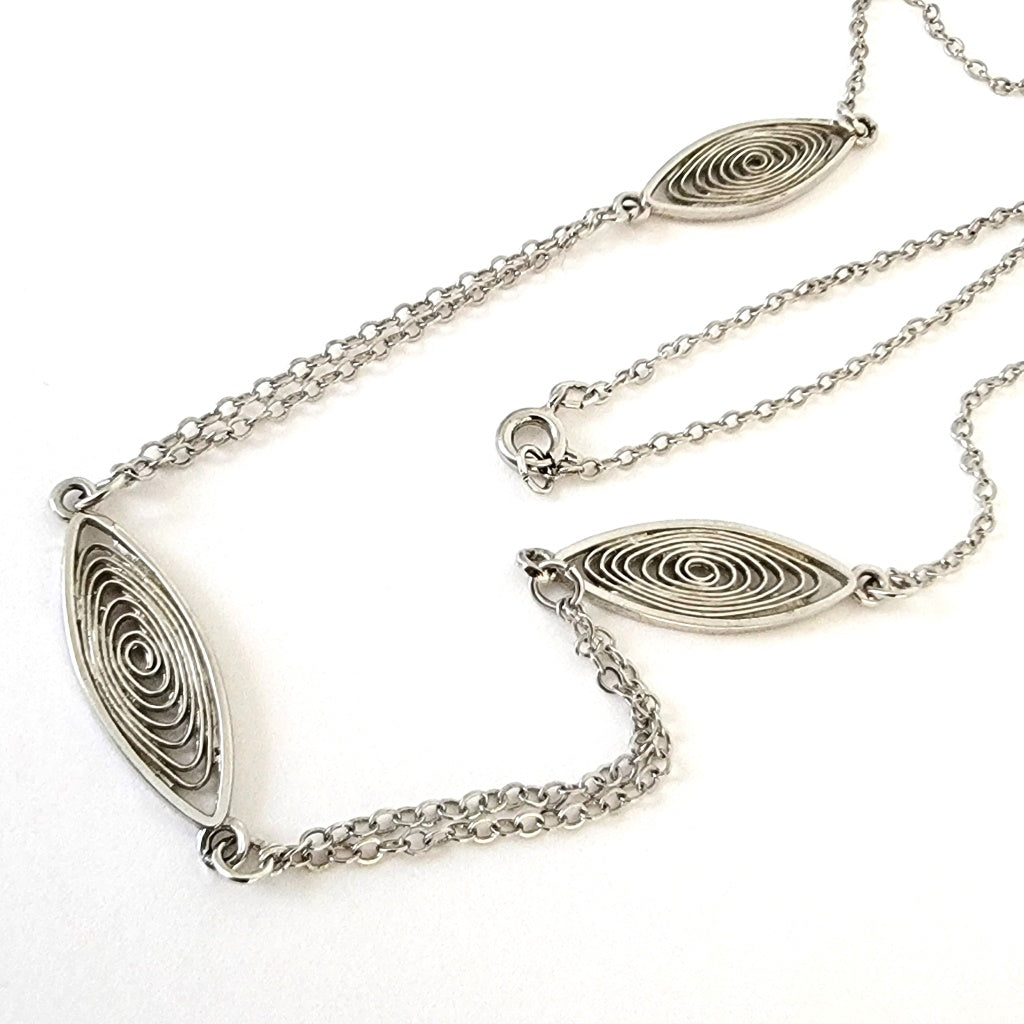 Silver tone necklace with spiral links.