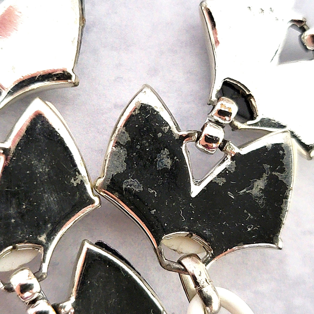 Detail of silver tone necklace plating.