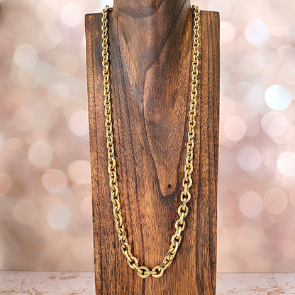Long gold chain on a wood display stand.