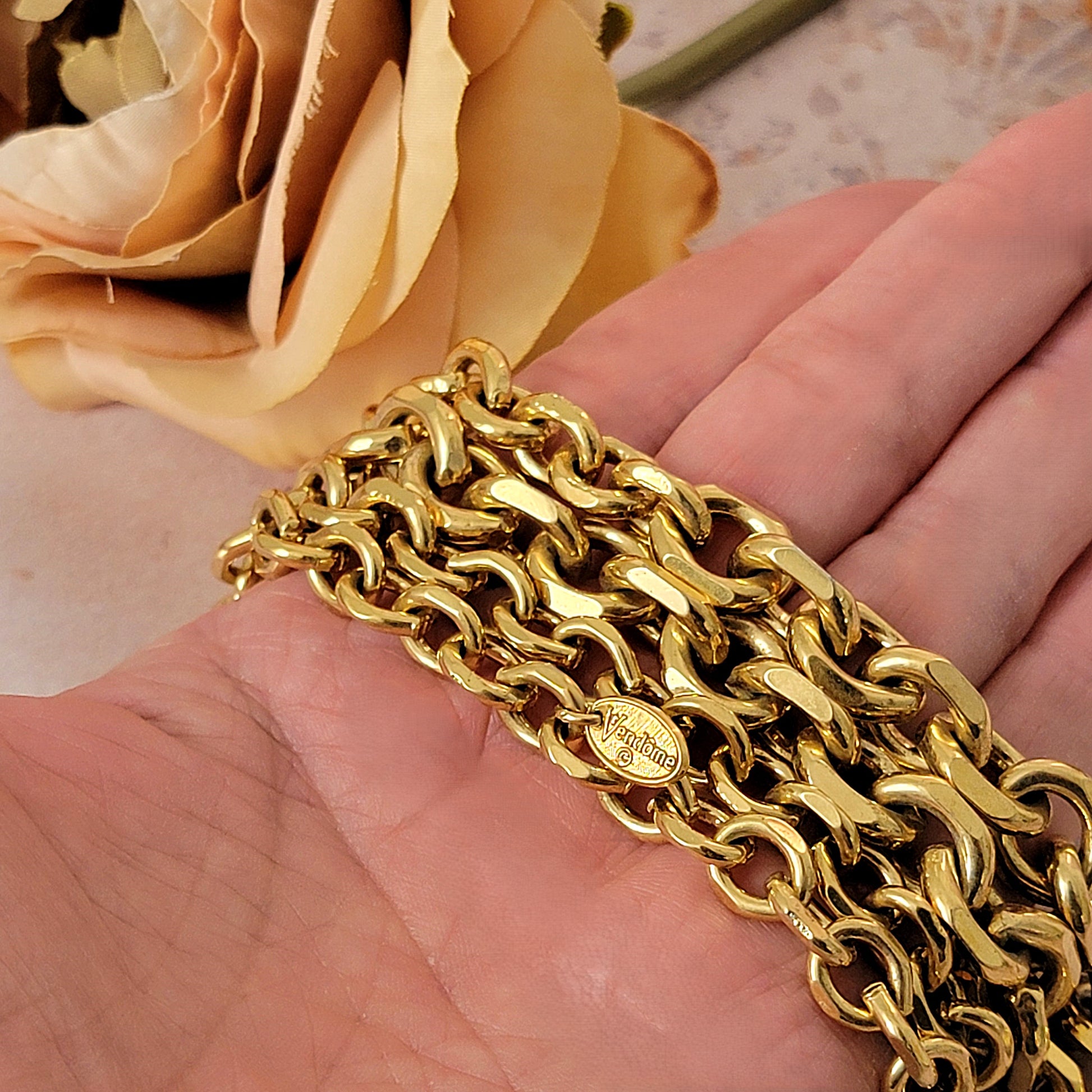 Gold chain in hand.