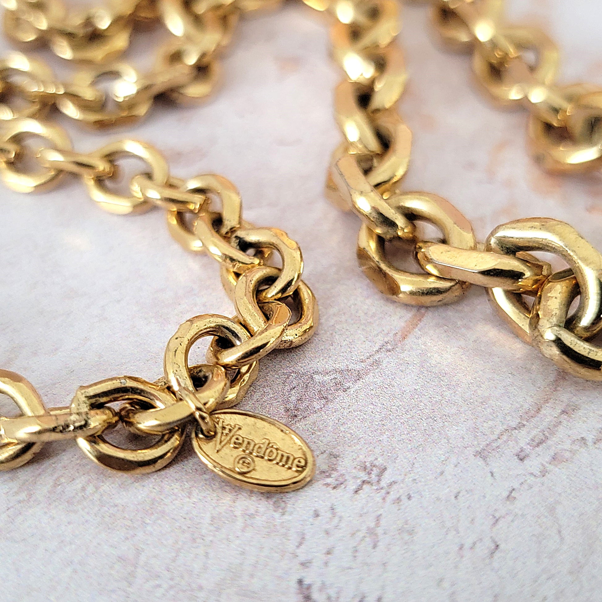 Vendome signature tag on a chain.
