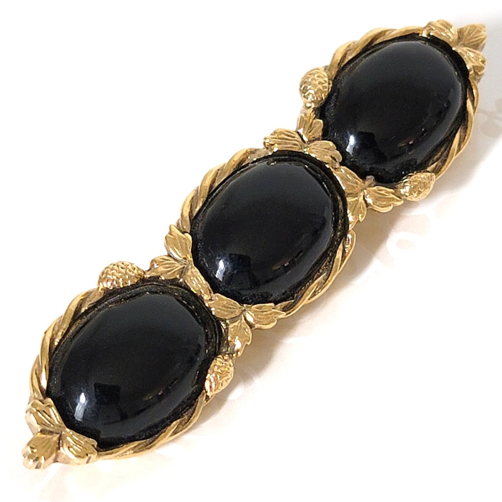 Black three cabochon bar brooch.