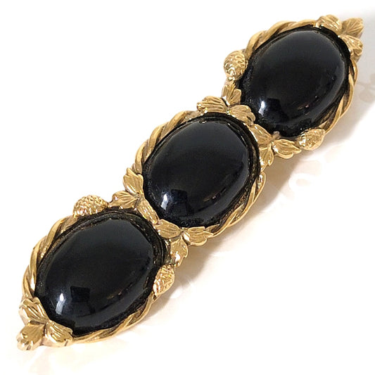 Black three cabochon bar brooch.