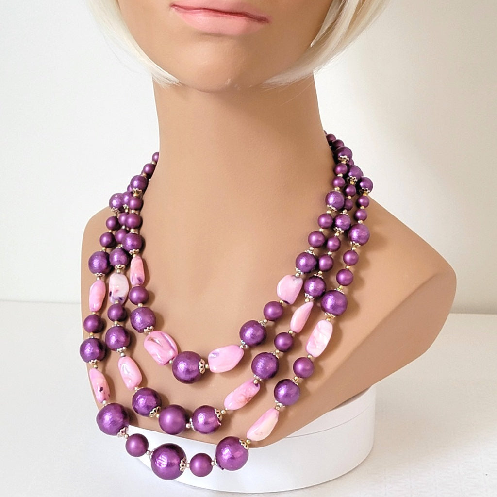 Vintage faux pearl necklace on a mannequin.