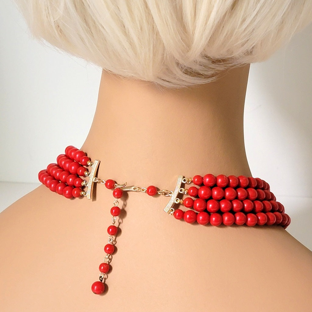 Back view of a four strand vintage red beaded choker, on a mannequin.