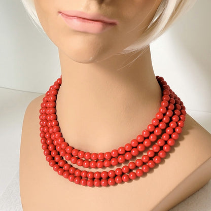 Vintage red four strand choker, shown on a mannequin.