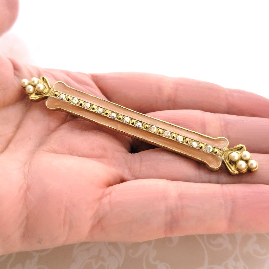 Vintage 1928 enamel, faux pearl and rhinestone skinny bar brooch, shown in hand, for size comparison.