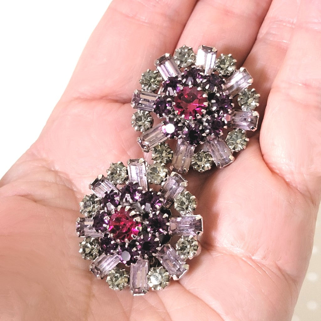 Vendome purple earrings in hand.