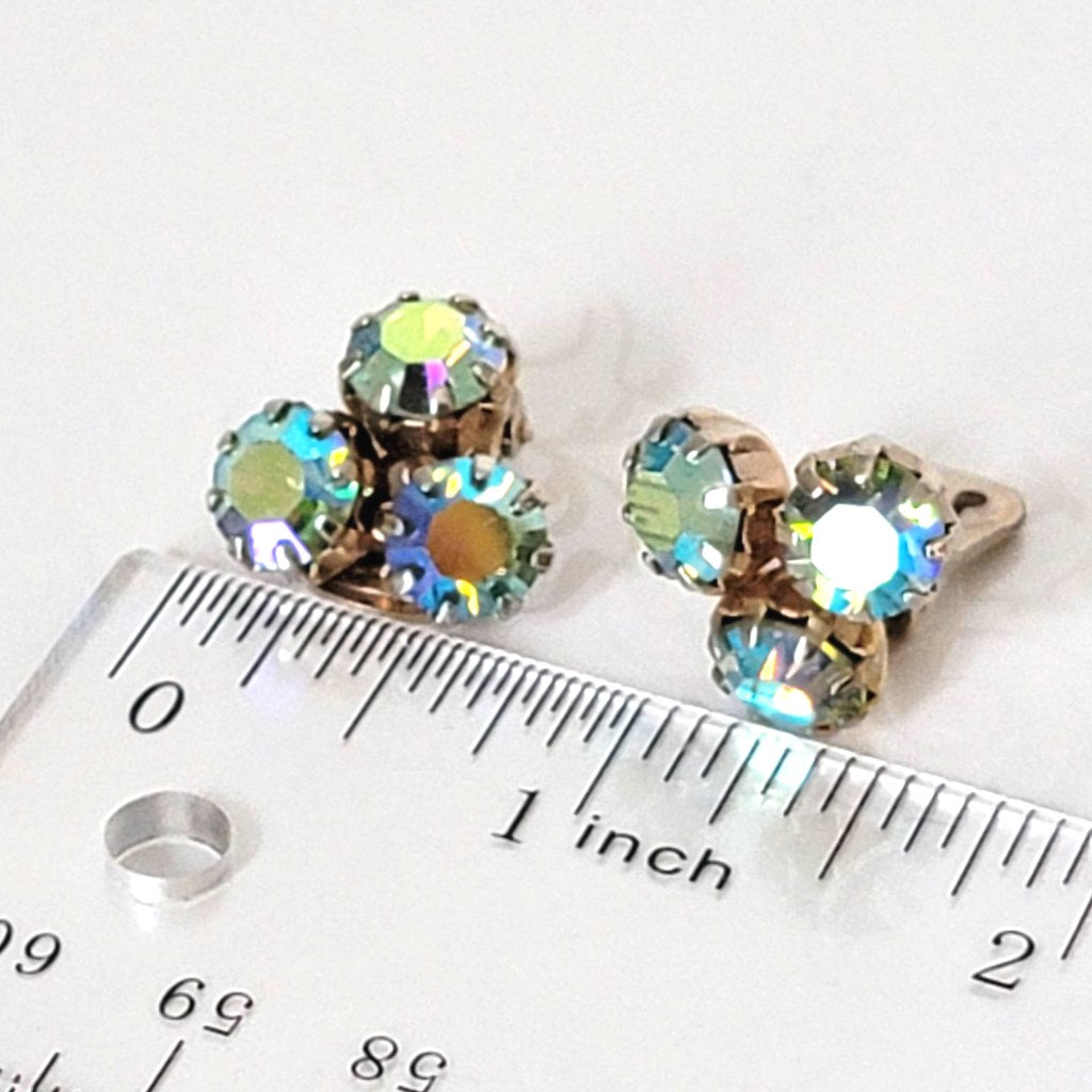 Weiss triple rhinestone clip-on earrings, with AB coating. Shown next to a ruler.