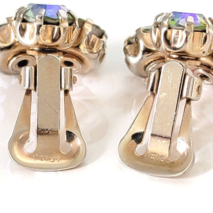 Closeup view of Weiss vintage earring clips, showing signature mark.