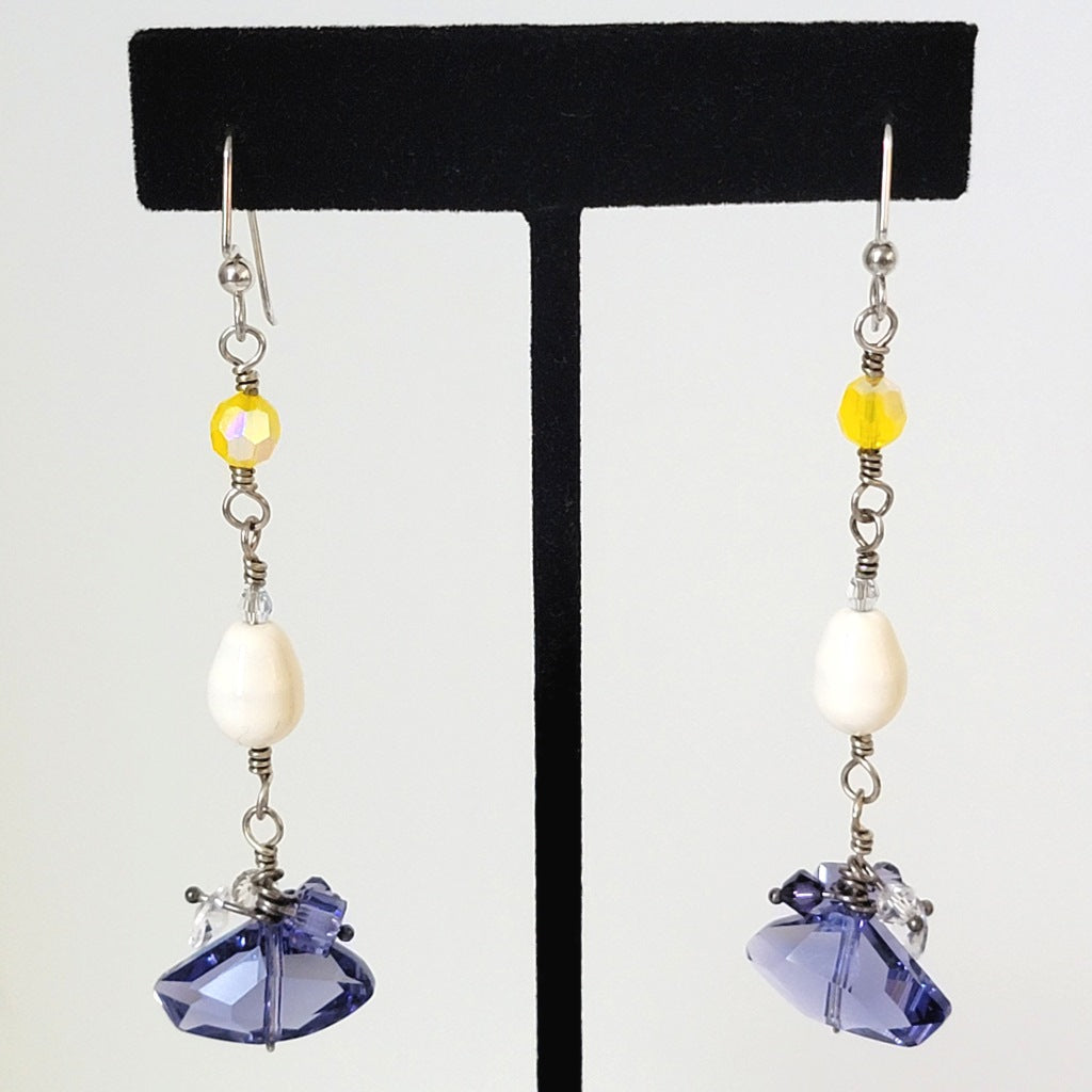 Long skinny purple and yellow silver wire earrings.