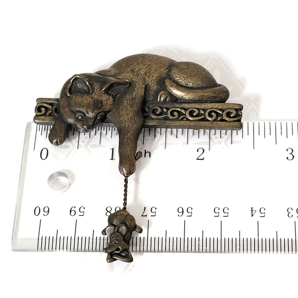 J Jonette cat brooch, with mouse charm, next to a ruler.