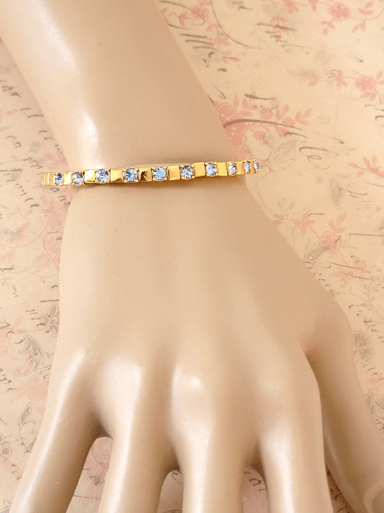 Joan Rivers icy blue rhinestone bracelet, skinny gold tone, flexible