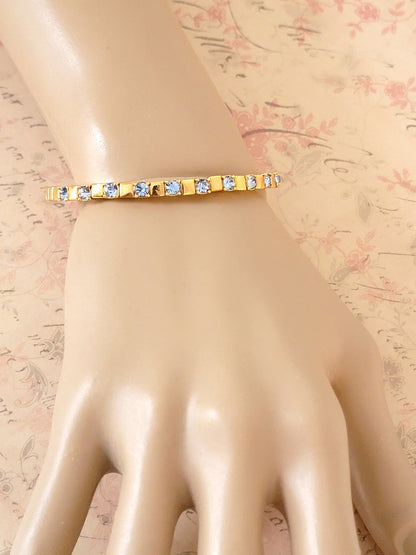 Joan Rivers icy blue rhinestone bracelet, skinny gold tone, flexible