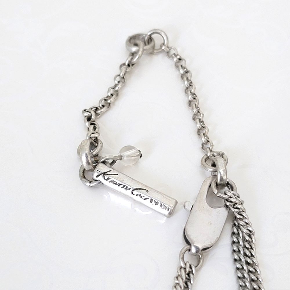 Kenneth Cole necklace clasp and logo tag.