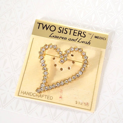 Two Sisters rhinestone heart brooch, on original card.