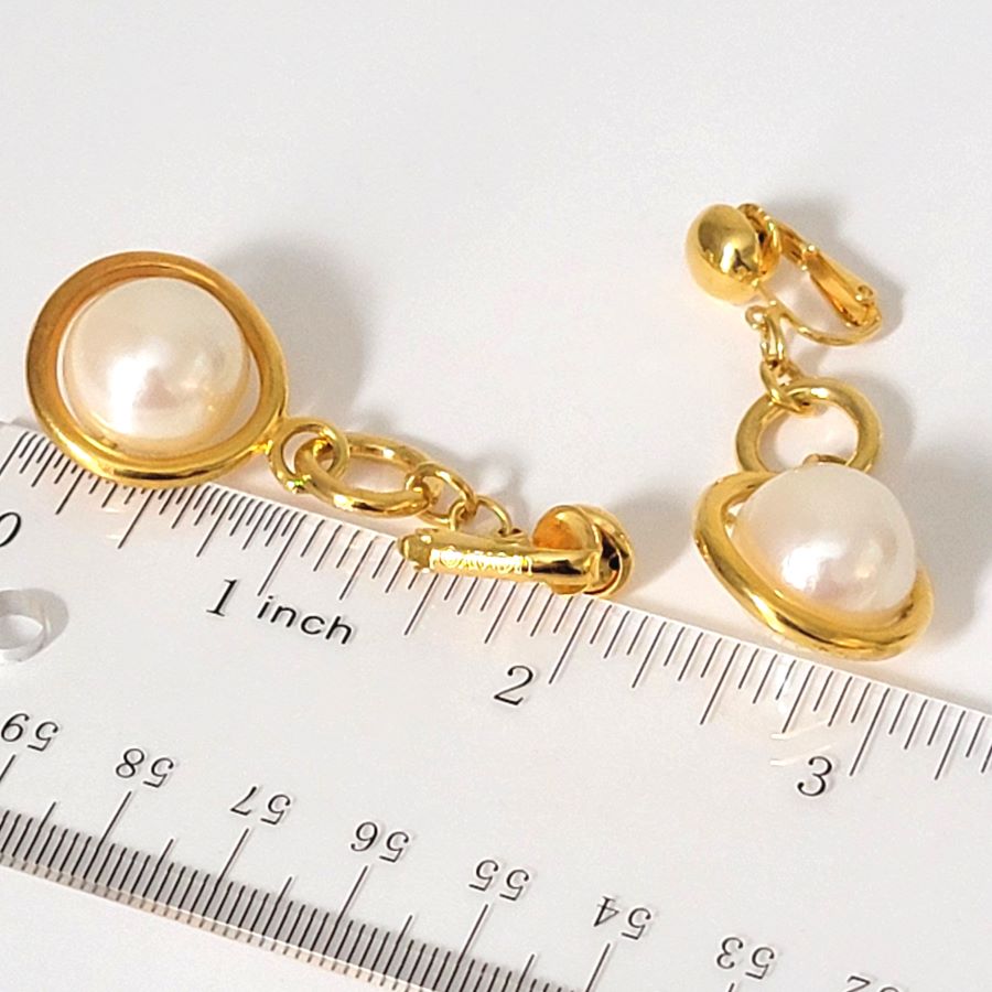 Avon faux pearl dangle clip on earrings, shown next to a ruler.