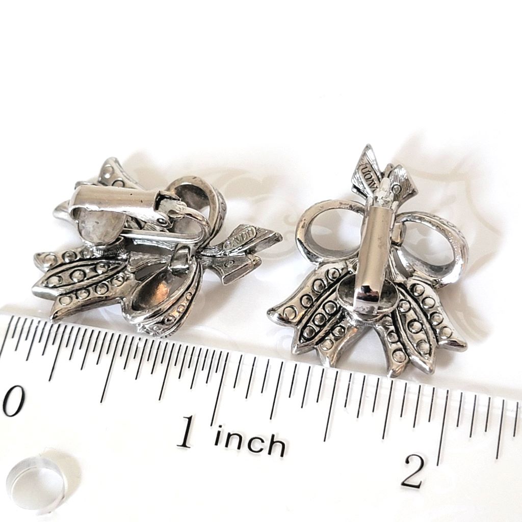 Back view of vintage avon, silver tone tulip clip-on earrings, shown next to a ruler.