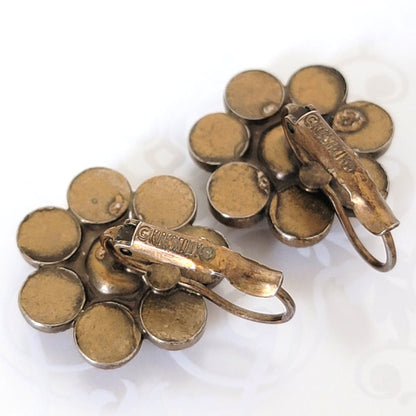 Back view of Kirks Folly rhinestone earrings, with lever backs, showing signatures.