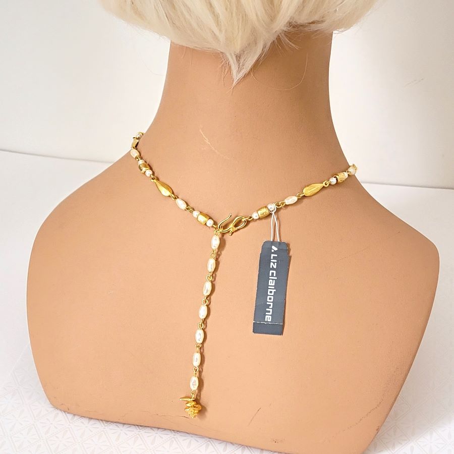 Liz Claiborne choker length back necklace, shown with its paper hang tag, on a mannequin.