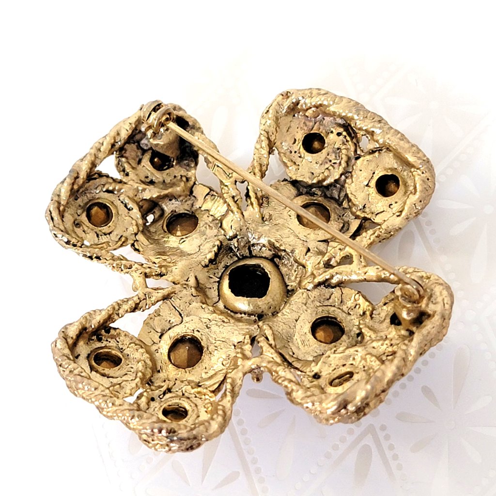Back view of big gold tone rhinestone Maltese cross brooch.