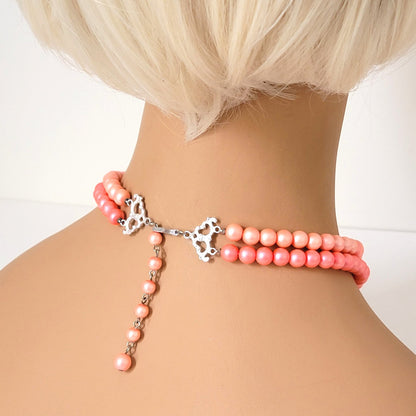 Back view of vintage orange faux pearl choker, on mannequin.