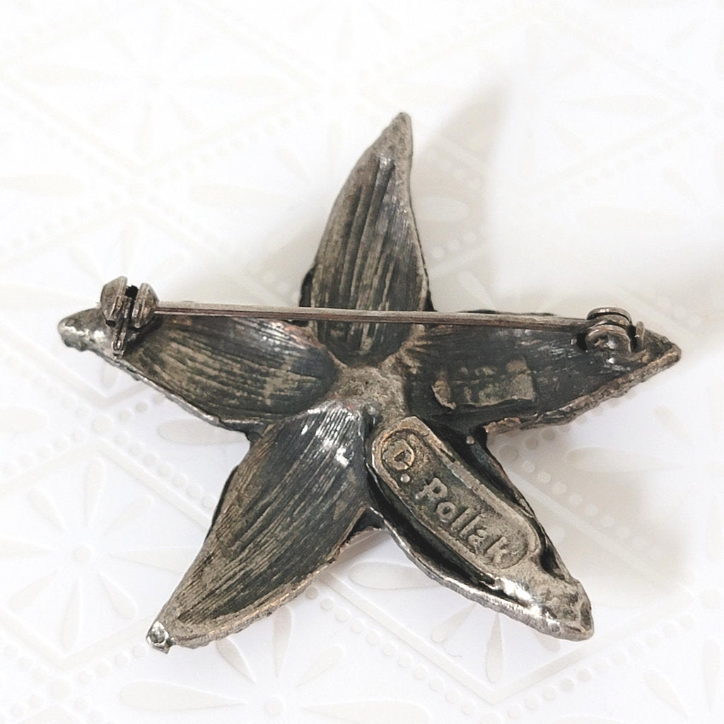 Back view of Pollak starfish pin, showing signature mark.