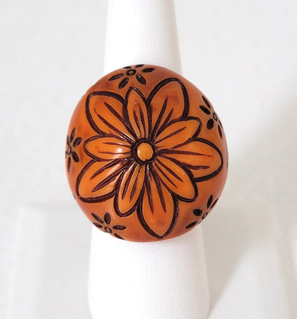 Big, chunky, boho, orangey brown plastic flower ring, dome style.